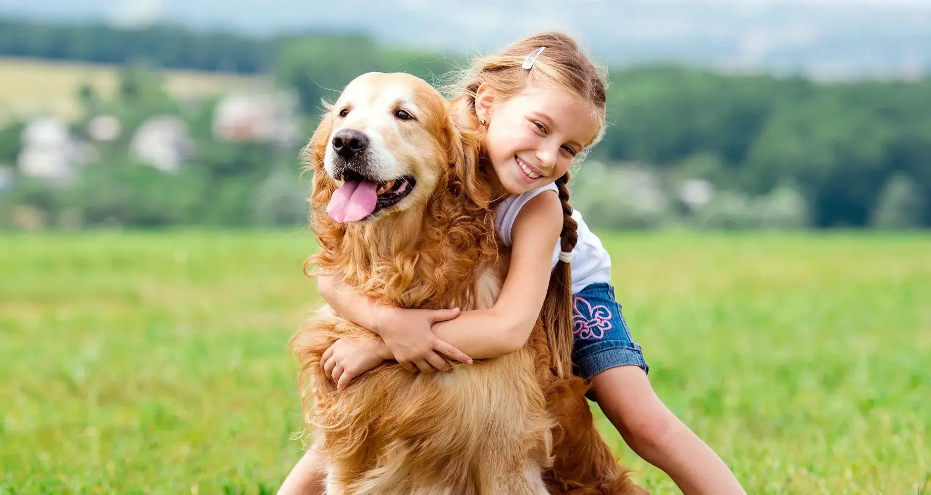 A smiling volunteer holding a happy puppy
